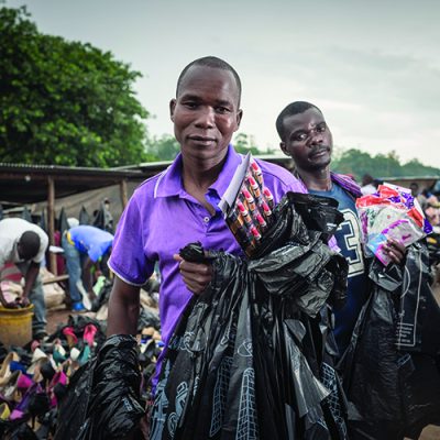 photo: Sven Torfinn. Malawi, Blantyre, December 2016.
Mayeso Gwanda selling plastic bags on the market in Blantyre. 
Mayeso Gwanda is a street vendor by trade and was arrested on his way to sell plastic bags. The applicant was charged under section 184(1)(c) and his criminal trial was subsequently stayed pending the determination of the constitutional petition filed by the applicant. The applicant submits that the offence is outdated and vague which results in its arbitrary enforcement by the police. The applicant submits that the offence results in a number of rights violations, including his rights to dignity, privacy, freedom from inhumane and degrading treatment, freedom and security of person, freedom from discrimination, and freedom of movement.
Section 184(1)(c) of the Penal Code provides that “every person found in or upon or near any premises of in any road or highway or any place adjacent thereto or in any public place at such time and under such circumstances as to lead to the conclusion that such person is there for an illegal or disorderly purpose, is deemed a rogue and vagabond.” The offence has frequently been criticised by civil society, academics and the courts for the arbitrary manner in which it has been enforced. The offence of being a rogue and vagabond exists in the same wording in the Penal Codes of many African countries and dates back to the era when these countries were subjected to British colonial rule, including Nigeria, Gambia, Zambia, Uganda, Botswana, Seychelles, and Tanzania.
On the 10th of January 2017 his case will be in court for review.